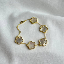 Load image into Gallery viewer, Gold bracelet with white clover-shaped mother of pearl charms.
