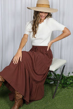 Load image into Gallery viewer, Woman wearing a white top and brown skirt with a wide-brimmed hat, sitting on a chair.