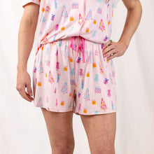 Load image into Gallery viewer, Festive Twinkle Tree family pajama collection with whimsical trees, gifts, and pink trim.