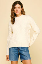 Load image into Gallery viewer, Woman wearing a cream sweater and denim shorts against a beige background