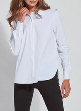 Load image into Gallery viewer, Image of a woman in white shirt and black pants, modeling the Connie Slim Button Down with a curved hemline and wrinkle-resistant Microfiber fabric.