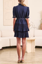 Load image into Gallery viewer, Woman wearing a navy dress in a living room setting