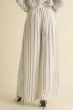 Load image into Gallery viewer, Striped jumpsuit worn by a person on a beige background