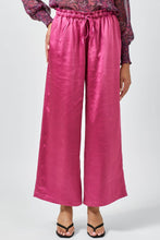 Load image into Gallery viewer, Pink wide-leg pants worn by a person on a white background