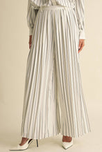 Load image into Gallery viewer, Person wearing a striped outfit with wide-leg pants on a beige background