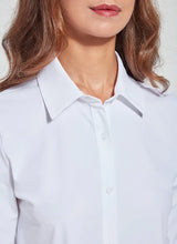 Load image into Gallery viewer, A woman wears a slim-fit long button-down shirt with high-quality details like classic collar, button-front close, single button cuffs, and asymmetrical hemline.