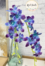Load image into Gallery viewer, A stunning arrangement of lifelike purple flowers in a vase, featuring real touch faux orchids with bendable stems for a realistic touch.