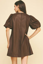 Load image into Gallery viewer, Woman wearing a brown dress with puff sleeves on a beige background