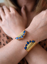 Load image into Gallery viewer, Gold bracelets with blue stones on a person's wrist