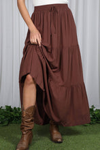 Load image into Gallery viewer, Brown tiered skirt worn by a person on a grassy area with white curtain background