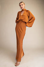 Load image into Gallery viewer, Woman wearing a brown outfit against a beige background