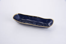 Load image into Gallery viewer, Shows off bread, asparagus, green beans, crackers, or cookies. Blue glazed porcelain with gold-tone rims. Suitable for food, dishwasher, oven (up to 500°). Resistant to tarnish and stains. Convenient to care for.