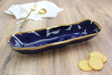 Load image into Gallery viewer, Luxurious blue glazed porcelain with gold-tone rims. Perfect for bread, crackers, or cookies. Food safe, easy to clean.