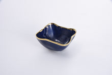 Load image into Gallery viewer, Enjoy snacks in the Sunset By The Sea square bowl, ideal for individual snacking, dips, or toppings. Perfect for taco, sundae, or pizza night! Crafted in luxurious blue glazed high-fired porcelain with vibrant gold-tone rims. Food safe, tarnish free, dishwasher and oven safe to 500°. Easy Care.