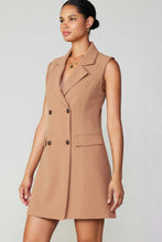 Load image into Gallery viewer, A model wearing a tan dress with a buttoned front. Sleeveless double-breasted longline vest dress exuding elegance and style.