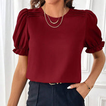 Load image into Gallery viewer, Red blouse with puff sleeves worn by a person against a white wall