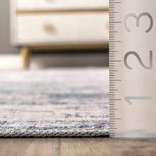 Load image into Gallery viewer, A ruler on the floor beside a chic Oriental/Persian rug. This machine-made rug from China has a flat pile and integrated non-slip backing, adding to its sleek and sophisticated look.