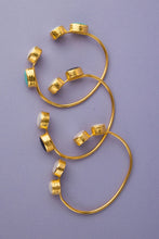 Load image into Gallery viewer, Unique open bangle featuring four stones set in textured gold, ideal for stacking and crafted with care for a comfortable fit.