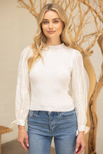 Load image into Gallery viewer, Woman wearing a white blouse and blue jeans with a decorative background
