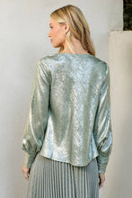 Load image into Gallery viewer, Woman wearing a metallic green blouse against a white wall