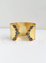 Load image into Gallery viewer, Gold cuff bracelet with gray stones on a white background