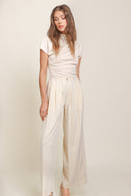 Load image into Gallery viewer, Cream top and wide leg pants by Line and Dot. Luxurious Ecru hue, classic yet modern design, crafted with premium materials for exquisite style.