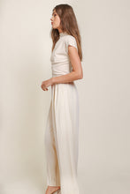 Load image into Gallery viewer, A model in cream top and wide leg pants by Line and Dot. Luxurious Ecru hue, classic yet modern design, crafted with premium materials.