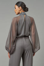 Load image into Gallery viewer, Chic and sassy Tie-Neck Raglan Blouse from Lola & Sophie. Unique twist with see-through arms and fun touch of a neck tie. Spice up your wardrobe and wow everyone!