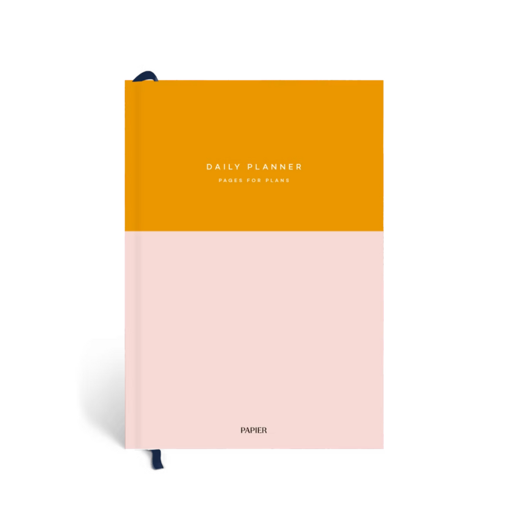 A colorful daily planner featuring orange and pink hues, perfect for boosting productivity and keeping you organized.