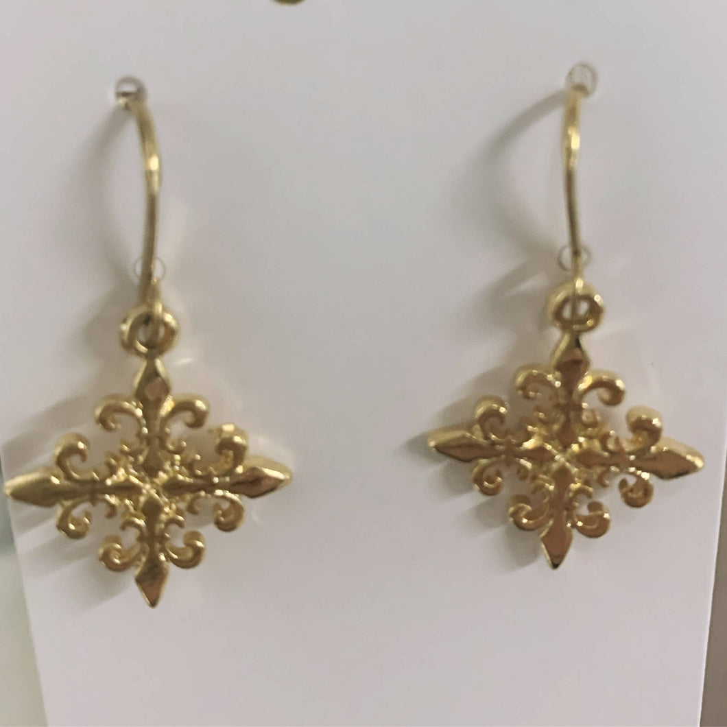 Gold Fleur de lis motif earrings.
