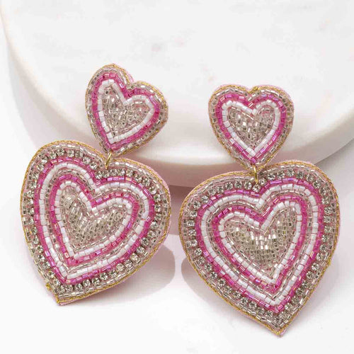 Love Spell earrings with heart-shaped beads for a charming touch to any outfit, sure to enchant and receive compliments.