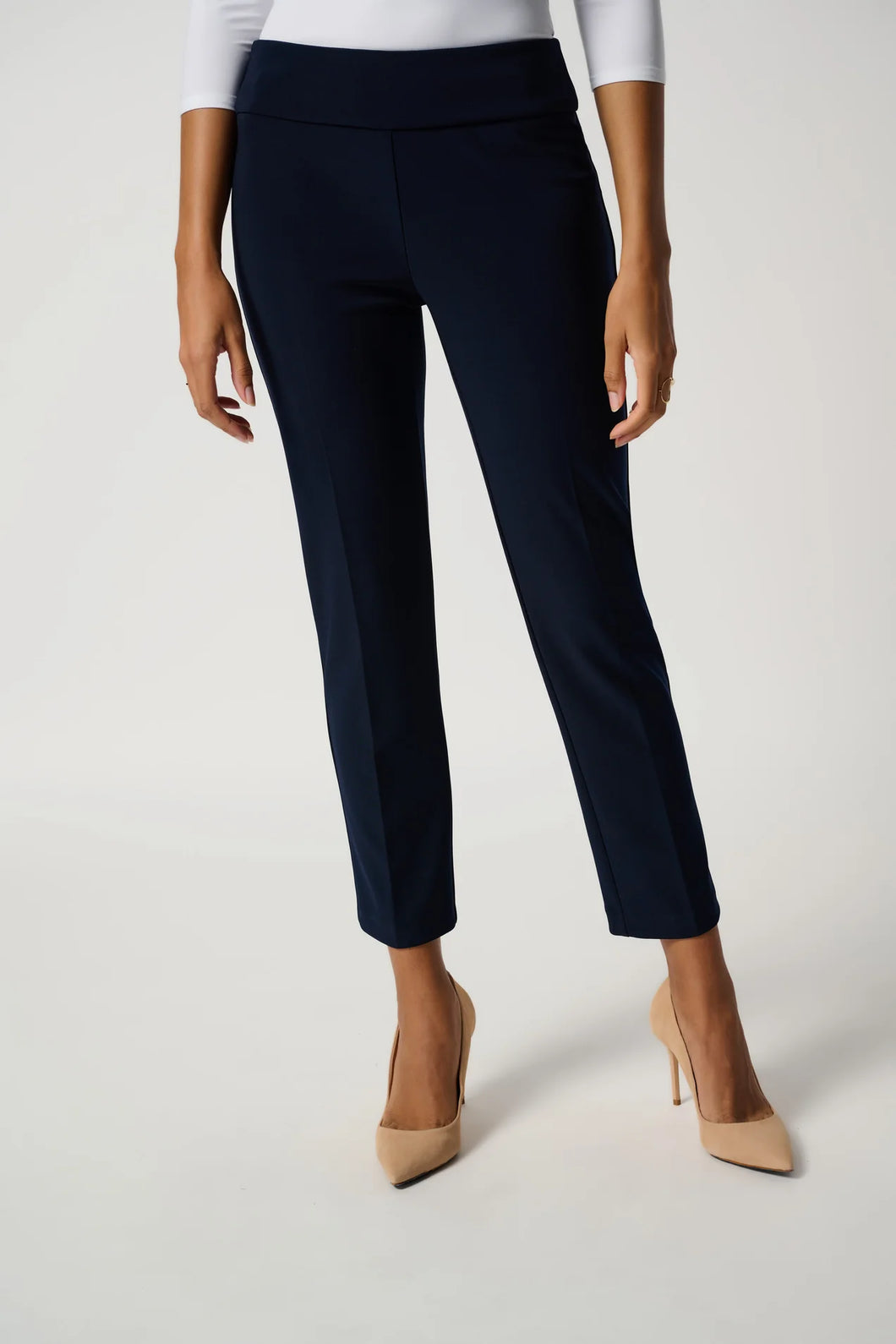 Navy blue pants worn by a person on a white background