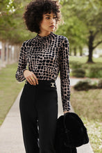 Load image into Gallery viewer, Stylish animal print top made of jersey fabric with long sleeves, fitted silhouette, and mock neck. Perfect for dressing up or keeping casual.
