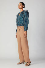Load image into Gallery viewer, A fashionable ensemble featuring a model wearing a blue blouse and wide-leg trousers. The pleated pants have a partially elasticized waistband, providing a precise fit, while front and back pockets add a refined touch.
