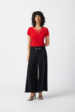 Load image into Gallery viewer, Stylish woman in red top and black wide-leg pants, featuring a wide waistband and gold accent, radiating timeless elegance.
