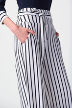 Load image into Gallery viewer, Fashionable woman in striped pants and a black and white striped shirt, exuding timeless style and elegance.
