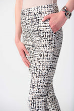 Load image into Gallery viewer,  Slim silhouette pants with a captivating abstract print, side pockets, and a polished faux fly.
