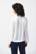 Load image into Gallery viewer, Chic satin top with notch collar, lapels, and centre-front ties. Puff sleeves adorned with gold buttons. Sleek yokes at front and back for style.
