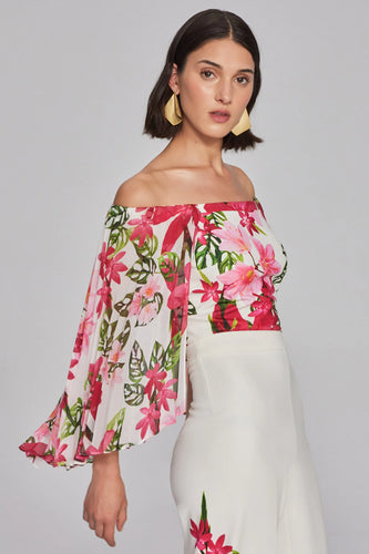 Scuba crepe chiffon off-shoulder top with floral print. Fitted design and pleated cape add elegance. Versatile piece from the Signature Collection.