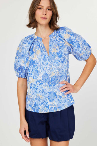 Vibrant stacked floral top with half sleeves, v-neck, and gathered detailing for a chic, comfortable look.
