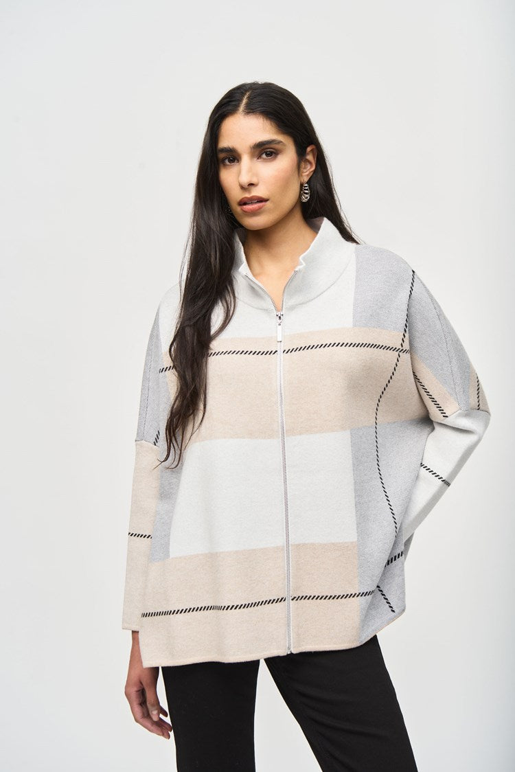 Stylish jacquard knit poncho cover-up with a three-tone color block design, mock neck, and practical front zipper closure.