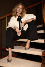 Load image into Gallery viewer, Stylish wide-leg denim pants featuring playful metallic trims on the waistband and a high waist for a flattering, elongated look.
