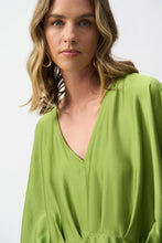 Load image into Gallery viewer, Sophisticated hammered satin top with dramatic kimono sleeves, V-neckline, and pleats, emphasizing a sleek peplum silhouette.
