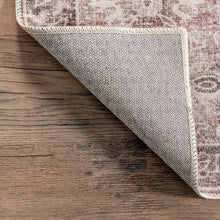 Load image into Gallery viewer, Light brown and beige Oriental rug on wooden floor; sleek, flat pile with non-slip backing for added functionality.
