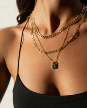 Load image into Gallery viewer, A chic woman donning a black top and elegant gold jewelry, including a versatile figaro chain necklace that measures 44 cm in length.
