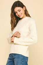 Load image into Gallery viewer, Woman wearing a white sweater and blue jeans against a beige background
