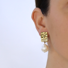 Load image into Gallery viewer, Elegant clip-on earrings featuring textured frames and large faux pearl dangles, embodying sophistication and style.

