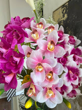 Load image into Gallery viewer, Elevate your centerpieces with a vase filled with real touch pink and white orchids. These beautiful artificial Cymbidium orchids exude sophistication and vibrant hues.
