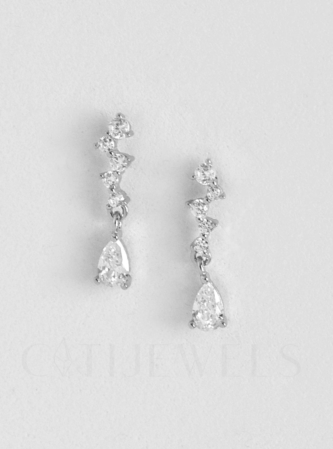 Two elegant diamond earrings featuring white gold accents, designed as mini chandelier CZ drop earrings in sterling silver.