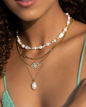 Load image into Gallery viewer, Elegant woman&#39;s necklace with a gold eye pendant adorned with clear and mint green zirconia crystals.
